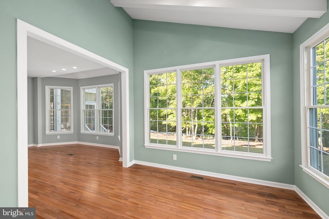 unfurnished sunroom with lofted ceiling