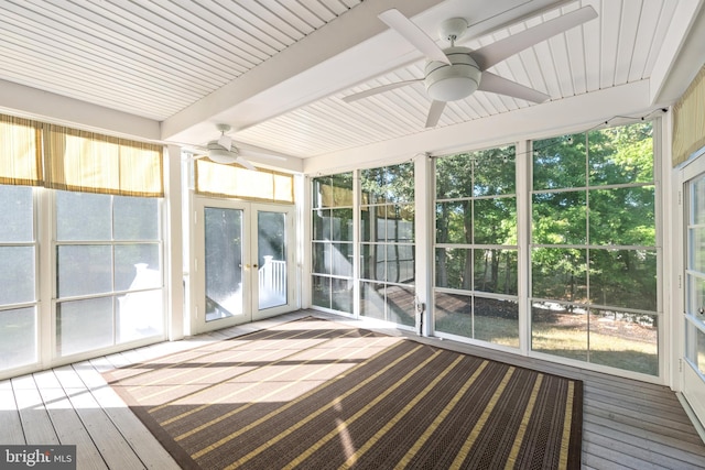 unfurnished sunroom with beam ceiling, plenty of natural light, and ceiling fan