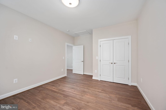 unfurnished bedroom featuring a closet and hardwood / wood-style floors