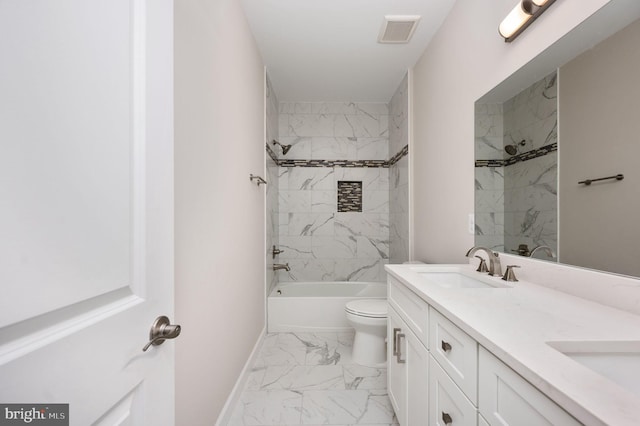 full bathroom with vanity, toilet, and tiled shower / bath