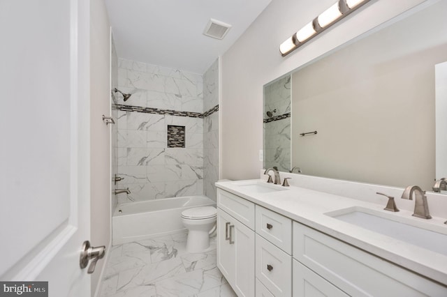 full bathroom featuring vanity, toilet, and tiled shower / bath