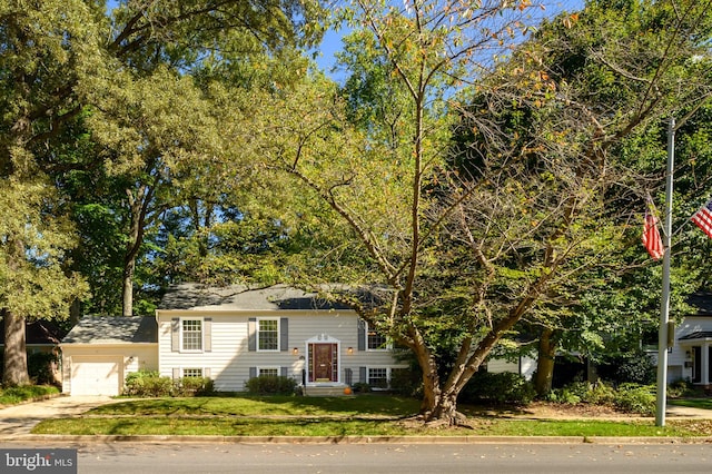 bi-level home featuring a garage and a front yard