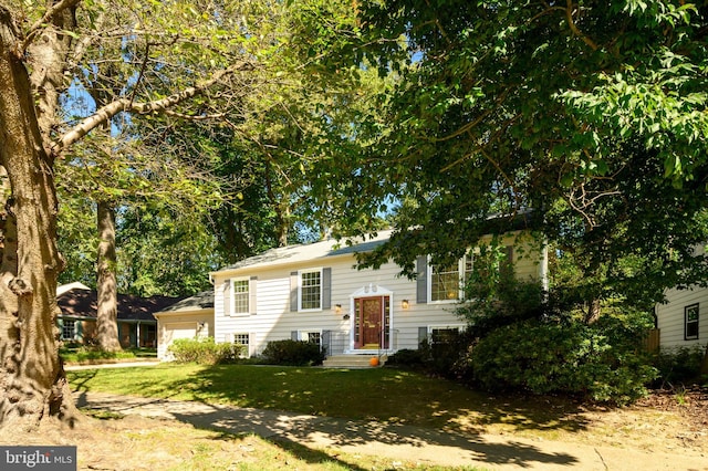 bi-level home with a front lawn and a garage