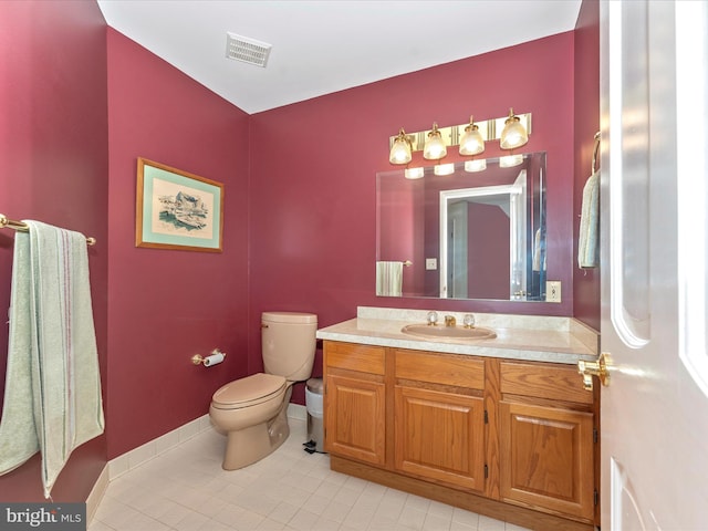 bathroom featuring vanity, toilet, and tile patterned floors