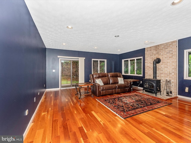 living room featuring light wood-type flooring and a wood stove