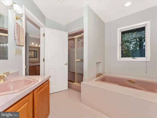 bathroom featuring independent shower and bath, vanity, and tile patterned floors