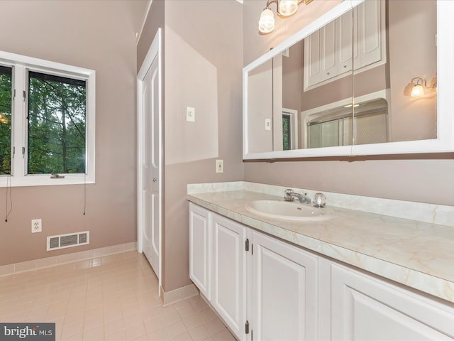 bathroom featuring tile patterned flooring and vanity