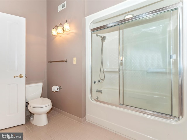 bathroom with tile patterned floors, enclosed tub / shower combo, and toilet