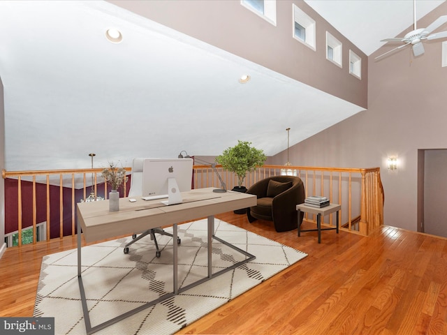 office space with hardwood / wood-style flooring, ceiling fan, and high vaulted ceiling