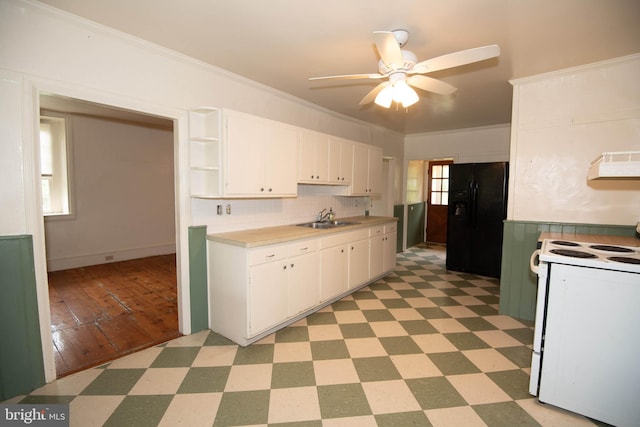 kitchen featuring white range oven, plenty of natural light, and white cabinets