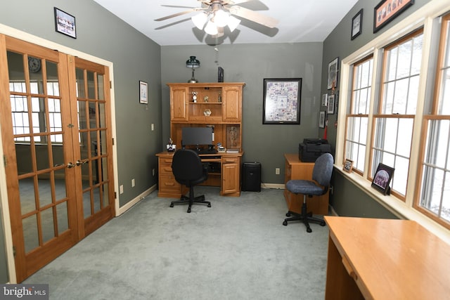 carpeted office space with french doors and ceiling fan