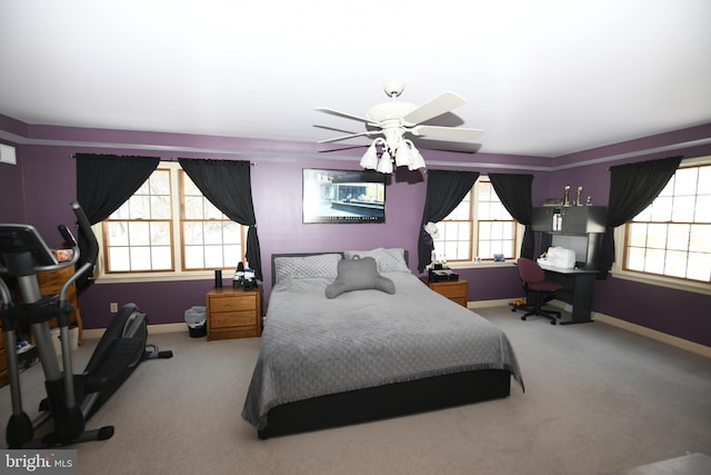 carpeted bedroom with multiple windows and ceiling fan