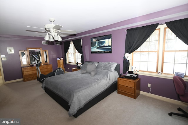 bedroom featuring ceiling fan, baseboards, visible vents, and carpet floors