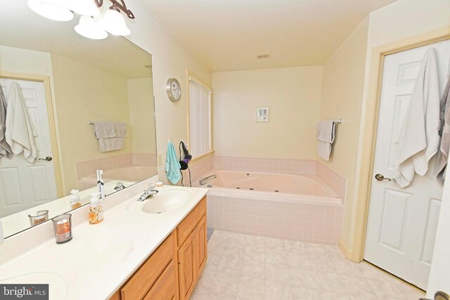 bathroom with double vanity, a whirlpool tub, and a sink