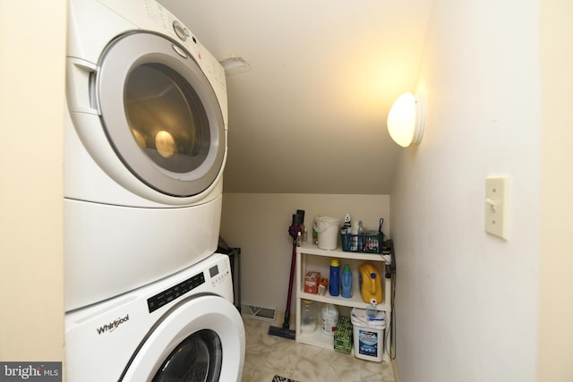 clothes washing area with stacked washer and clothes dryer