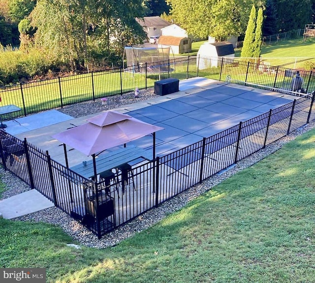 view of swimming pool featuring a lawn and a patio