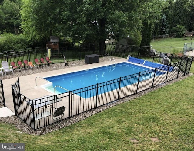 view of pool featuring a lawn and a patio