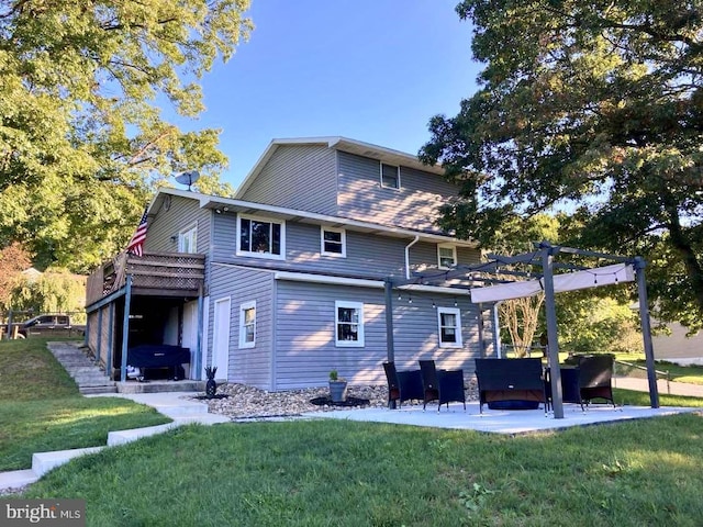 rear view of property with a lawn, a pergola, a patio, and a wooden deck