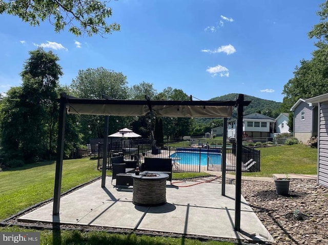 view of patio featuring a fenced in pool and a fire pit