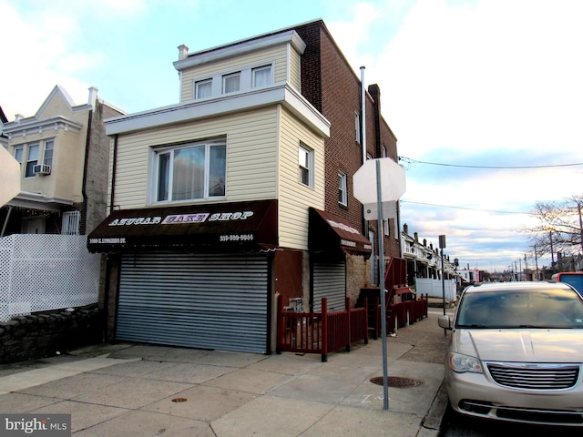 view of front of house featuring cooling unit and a garage