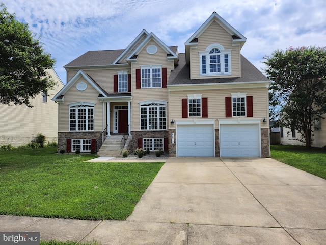 view of front of home with a front yard and a garage