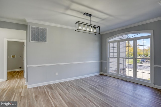 unfurnished dining area with ornamental molding and light hardwood / wood-style flooring