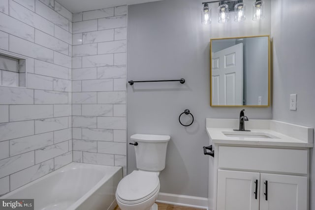 full bathroom with toilet, tiled shower / bath, and vanity