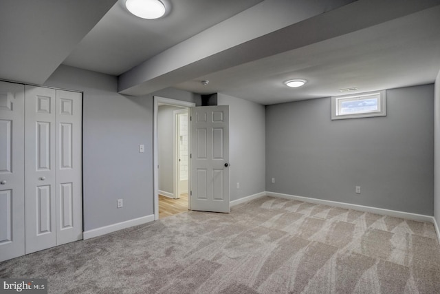 basement featuring light carpet