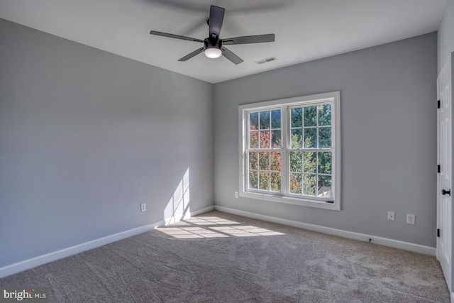 empty room with light colored carpet and ceiling fan