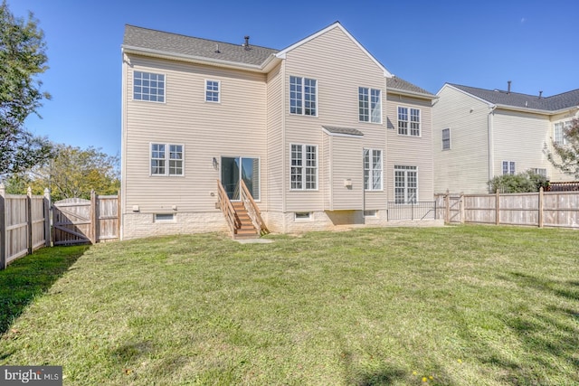 rear view of house featuring a lawn