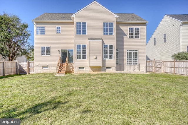 rear view of house with a lawn