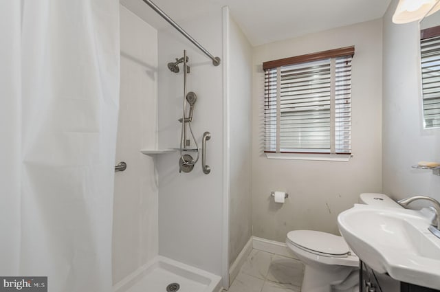 bathroom with sink, toilet, and walk in shower