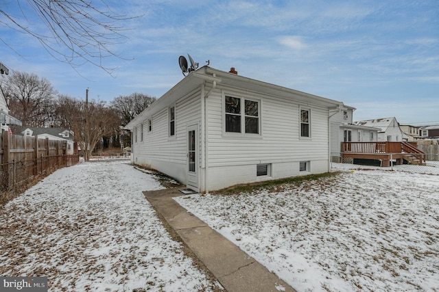 snow covered property with a wooden deck