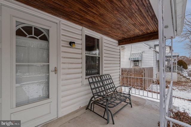 snow covered patio with a porch