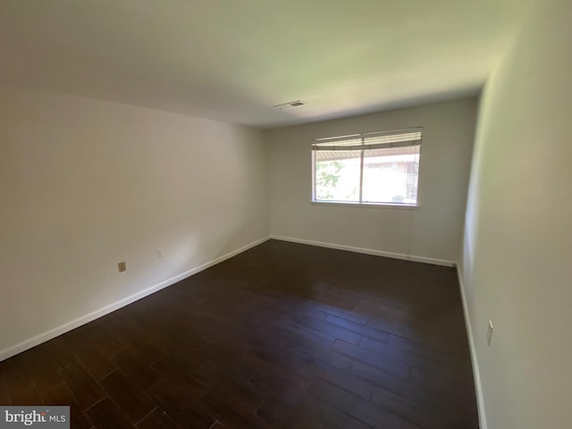 unfurnished room featuring dark hardwood / wood-style floors