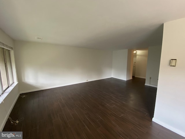 spare room with dark hardwood / wood-style floors