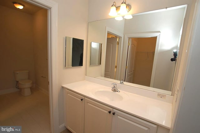 bathroom featuring vanity, toilet, tile patterned floors, and a notable chandelier