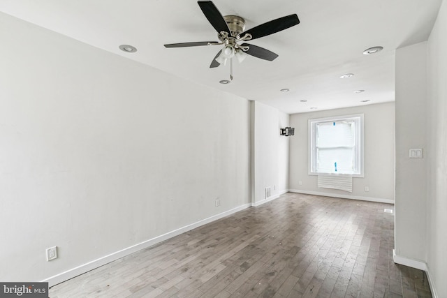 empty room featuring hardwood / wood-style floors and ceiling fan