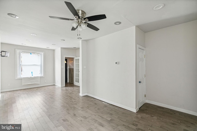 empty room with ceiling fan and hardwood / wood-style floors