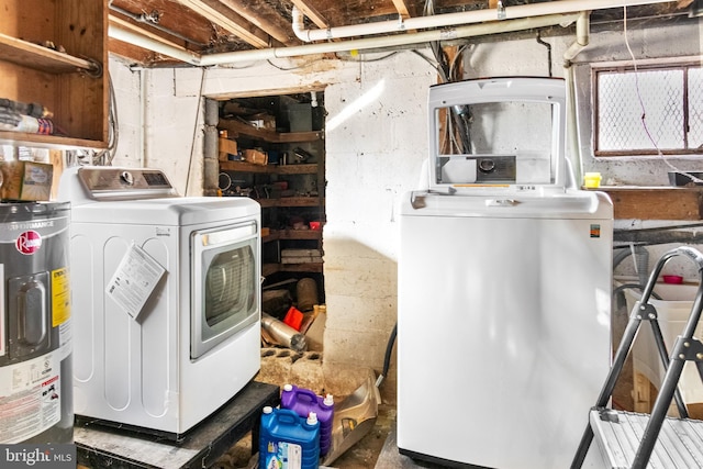 washroom with washing machine and dryer and water heater