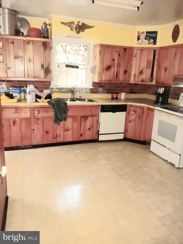 kitchen featuring white appliances, sink, and tasteful backsplash