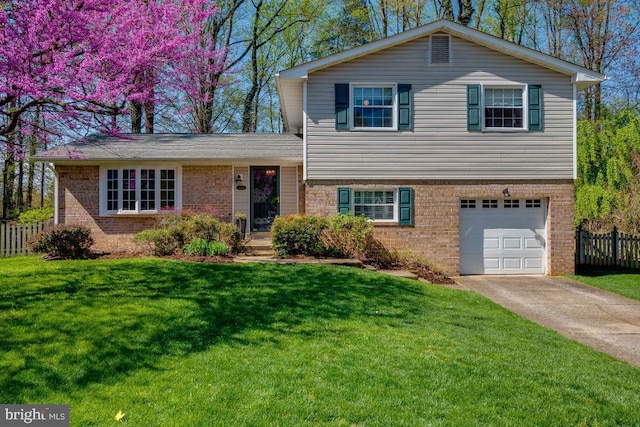 split level home featuring a garage and a front lawn