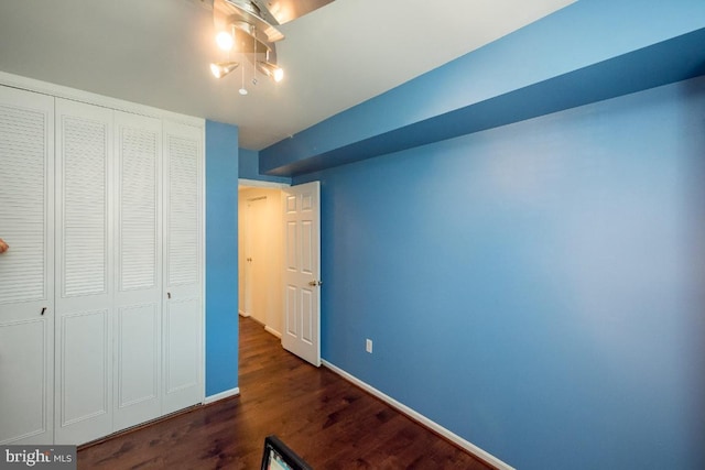 bedroom featuring a closet and dark hardwood / wood-style floors