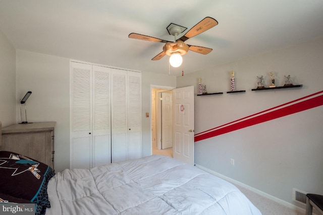 bedroom featuring a closet, light colored carpet, and ceiling fan