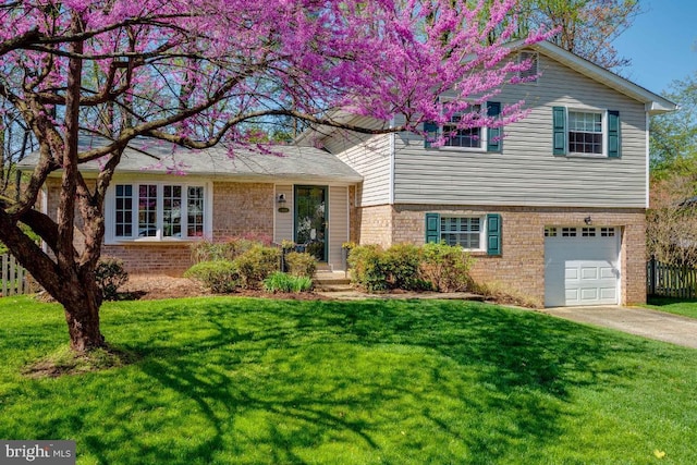 tri-level home with a front yard and a garage