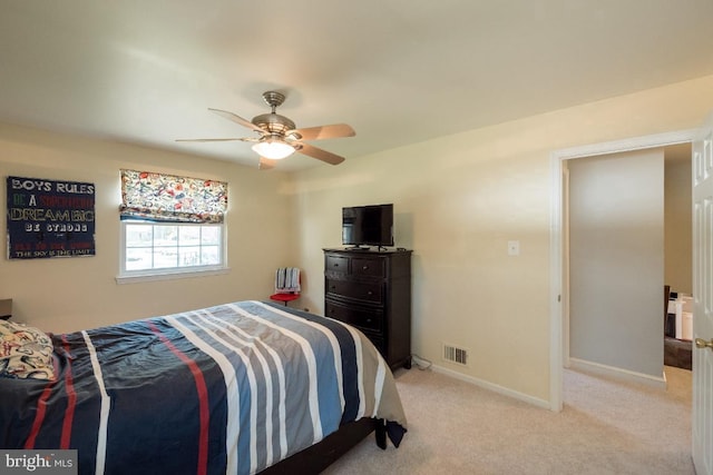 bedroom with light carpet and ceiling fan