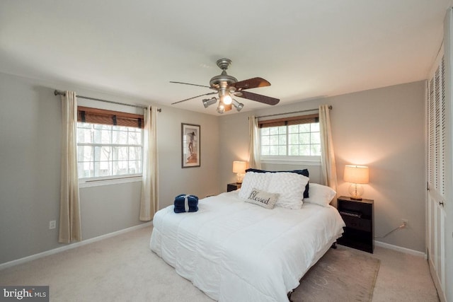 bedroom with light carpet, a closet, and ceiling fan