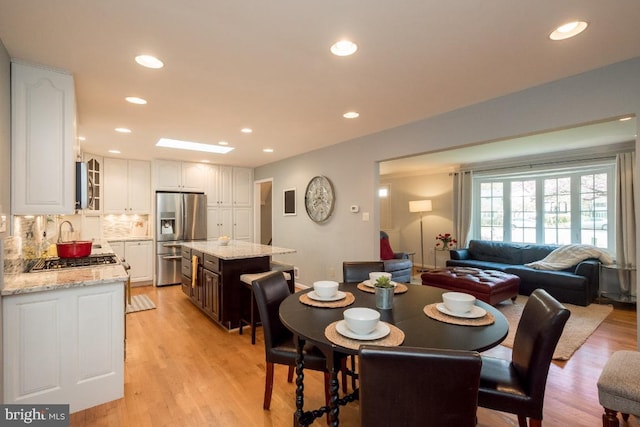 dining room featuring sink and light wood-type flooring