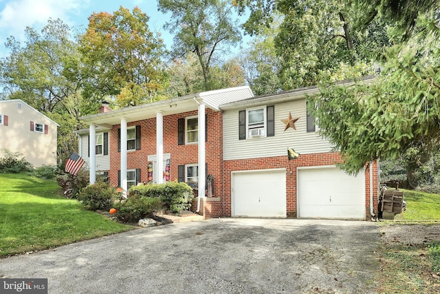 view of front of property featuring a garage and a front lawn