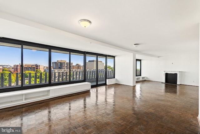 unfurnished room featuring parquet flooring and a wealth of natural light